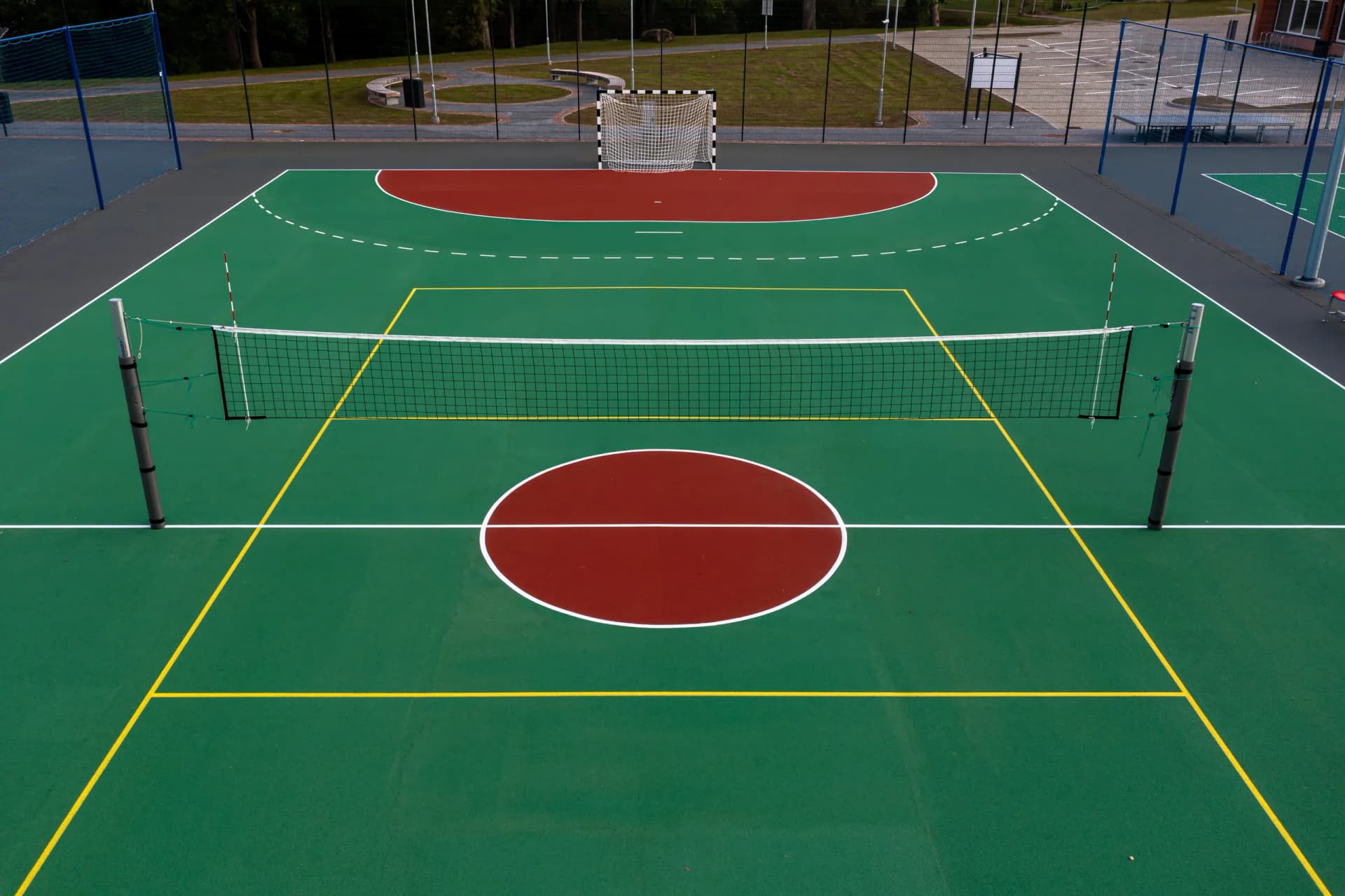 Multi-sport court with multi-color line striping for basketball, pickleball, and tennis school
